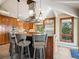 Spacious kitchen features wood cabinets, stainless steel appliances, breakfast bar, and hood vent at 24172 Jerome Ct, Golden, CO 80401