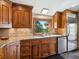 Kitchen with stainless steel appliances, wood cabinets, tile backsplash, and granite countertops at 24172 Jerome Ct, Golden, CO 80401