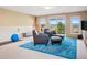 Basement living room with wainscotting, comfortable seating, and picturesque mountain views at 24172 Jerome Ct, Golden, CO 80401