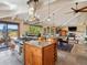 Open living space with a kitchen island, cooktop, dining area and living room at 24172 Jerome Ct, Golden, CO 80401