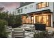 The backyard features a patio with modern outdoor seating, decorative rock, and lush landscaping at 2248 S Lincoln St, Denver, CO 80210