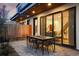 Modern patio with outdoor dining set and views into the home's stylish interior at 2248 S Lincoln St, Denver, CO 80210