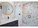 Modern bathroom with patterned tile shower, sleek vanity, and round mirror for a spa-like experience at 2248 S Lincoln St, Denver, CO 80210