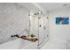 Bright bathroom featuring a glass-enclosed shower with rainfall showerhead and luxurious soaking tub at 2248 S Lincoln St, Denver, CO 80210