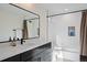 Modern bathroom features a black framed mirror, large vanity, and shower/tub combination at 2248 S Lincoln St, Denver, CO 80210