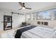 Bright bedroom with large windows, ceiling fan, and sliding barn door at 2248 S Lincoln St, Denver, CO 80210