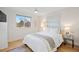 Bright bedroom with large window, ceiling fan, white bedding, and neutral decor for a calming atmosphere at 2248 S Lincoln St, Denver, CO 80210