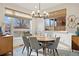 Bright dining room with a modern chandelier, large windows, and hardwood floors at 2248 S Lincoln St, Denver, CO 80210