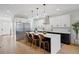 Modern kitchen with a center island, stainless steel appliances, and sleek black-and-white cabinetry at 2248 S Lincoln St, Denver, CO 80210