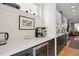 Coffee and wine bar with white quartz countertops, black cabinetry, and stainless steel appliances at 2248 S Lincoln St, Denver, CO 80210
