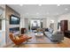 Open-concept living room with a fireplace, hardwood floors, and sliding glass doors to an outdoor patio at 2248 S Lincoln St, Denver, CO 80210