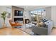 Cozy living room featuring a fireplace, hardwood floors, modern furniture, and sliding glass doors that lead to an outside patio at 2248 S Lincoln St, Denver, CO 80210
