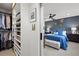 Open-concept closet and main bedroom with a blue accent wall and plush bedding at 2248 S Lincoln St, Denver, CO 80210