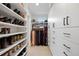 Bright walk-in closet featuring custom shelving, drawers, and ample hanging space for organized storage at 2248 S Lincoln St, Denver, CO 80210