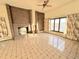 Living room with brick fireplace and tiled floor at 6861 Oberon Rd, Arvada, CO 80004