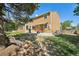 Spacious backyard featuring a patio area, mature trees, and a well-maintained lawn at 3285 W 11Th Avenue Ct, Broomfield, CO 80020