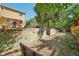 Spacious backyard featuring a retaining wall and stair access to an upper level with a patio at 3285 W 11Th Avenue Ct, Broomfield, CO 80020