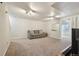 Finished basement featuring neutral carpeting, recessed lighting and a gray sofa with decorative pillows at 3285 W 11Th Avenue Ct, Broomfield, CO 80020