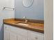 Charming bathroom vanity with a wood countertop and round mirror, blending rustic and modern styles at 3285 W 11Th Avenue Ct, Broomfield, CO 80020
