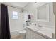 A bright bathroom features a tub/shower combo, a window and a modern vanity at 3285 W 11Th Avenue Ct, Broomfield, CO 80020