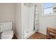 A bright bathroom features a shower, a toilet and a window with natural light at 3285 W 11Th Avenue Ct, Broomfield, CO 80020