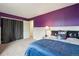 A bedroom features vibrant purple walls, carpeting and ample natural light at 3285 W 11Th Avenue Ct, Broomfield, CO 80020