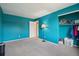 The bedroom includes carpeting, ample storage and bright teal walls at 3285 W 11Th Avenue Ct, Broomfield, CO 80020
