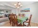 Formal dining room with a chandelier, seating for eight, and a large landscape painting at 3285 W 11Th Avenue Ct, Broomfield, CO 80020