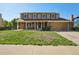 Charming two-story home with a brick and tan facade, solar panels, and a covered front porch at 3285 W 11Th Avenue Ct, Broomfield, CO 80020