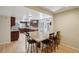 Bright kitchen features granite countertops, wood cabinets, and a large island with breakfast bar at 3285 W 11Th Avenue Ct, Broomfield, CO 80020
