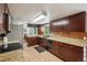 Spacious kitchen featuring wooden cabinets, a stainless steel refrigerator, and views to a dining area at 3285 W 11Th Avenue Ct, Broomfield, CO 80020