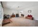 Open living area with natural light, featuring a cozy armchair and ample space for relaxation at 3285 W 11Th Avenue Ct, Broomfield, CO 80020