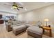 Spacious living room with neutral walls and a comfortable sectional sofa under a decorative ceiling fan at 3285 W 11Th Avenue Ct, Broomfield, CO 80020