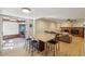 Open concept living room with access to the kitchen and a brick fireplace at 3285 W 11Th Avenue Ct, Broomfield, CO 80020