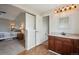 The main bathroom boasts a vanity with solid surface countertops and a view into the bedroom at 3285 W 11Th Avenue Ct, Broomfield, CO 80020