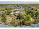Aerial view of condo complex with community pool, tennis courts, and lush greenery on a sunny day at 1306 S Parker Rd # 162, Denver, CO 80231