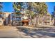 Condo building featuring tan walls, brick accents, balconies, and covered entrance way with bench seating at 1306 S Parker Rd # 162, Denver, CO 80231