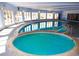 Indoor pool and hot tub area with ample natural light and curved design for recreation and relaxation at 1306 S Parker Rd # 162, Denver, CO 80231