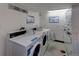 Brightly lit laundry room with coin-operated washing machines and mobile payment options at 1306 S Parker Rd # 162, Denver, CO 80231
