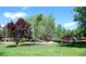 Scenic view of community pond with fountain, wooden bridge and surrounding trees at 1306 S Parker Rd # 162, Denver, CO 80231