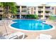 Inviting outdoor pool surrounded by lounge chairs and well-maintained landscaping at 1306 S Parker Rd # 162, Denver, CO 80231