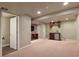 Finished basement includes a wet bar with cabinetry, stone accent wall, and entry to bathroom at 3495 Amber Sun Cir, Castle Rock, CO 80108