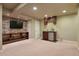 Finished basement with a stone accent wall, entertainment area, and a convenient wet bar with cabinetry at 3495 Amber Sun Cir, Castle Rock, CO 80108