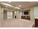 Spacious basement featuring a stone accent wall with built-in shelving, adjacent bathroom, and open floor plan at 3495 Amber Sun Cir, Castle Rock, CO 80108