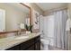 Bathroom featuring dark cabinets and a shower and tub combo at 3495 Amber Sun Cir, Castle Rock, CO 80108