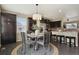 Bright dining area with modern lighting, a round table, and views of the backyard at 3495 Amber Sun Cir, Castle Rock, CO 80108