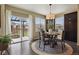 Cozy dining area with backyard views, sliding glass doors, and modern lighting at 3495 Amber Sun Cir, Castle Rock, CO 80108