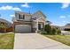 Charming two-story home with stone accents, a well-manicured lawn, and a spacious driveway at 3495 Amber Sun Cir, Castle Rock, CO 80108