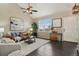 Cozy living room with hardwood floors, large windows, and stylish furnishings at 3495 Amber Sun Cir, Castle Rock, CO 80108