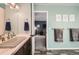 Bright bathroom features updated vanity with modern fixtures and view into a bedroom at 17509 E Kenyon Dr, Aurora, CO 80013